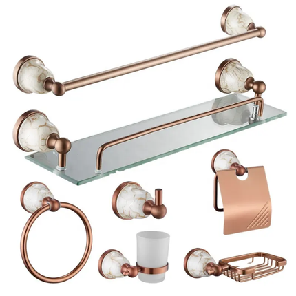 Bathroom accessory set with rose gold fixtures on a white background