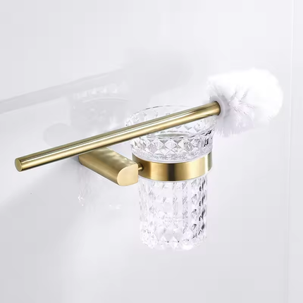 Ensemble d'accessoires de salle de bain en métal doré brossé comprenant un support de toilette et une brosse. 