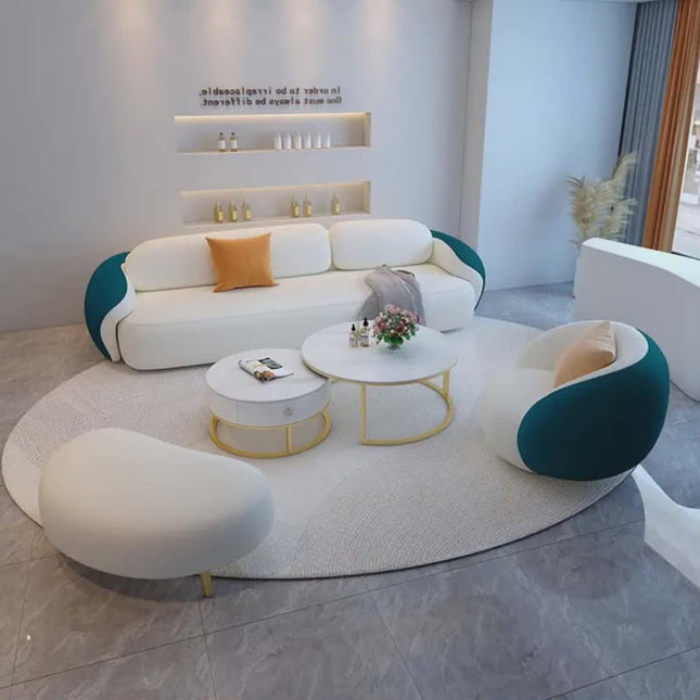 Modern living room with a white and teal sofa set, coffee tables, and decorative items.