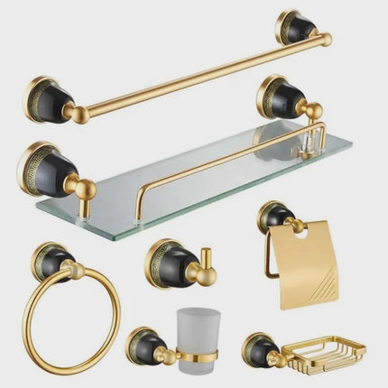 Bathroom accessory set with gold and black fixtures on a white background