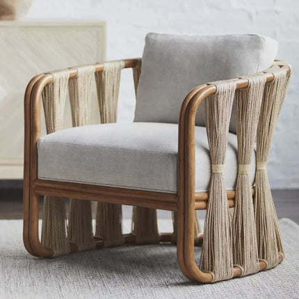 Chair with wooden frame and light gray cushion on a neutral background