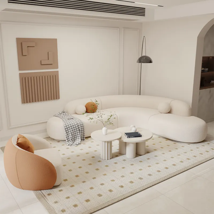 Modern living room with a white sofa, brown chair, and decorative elements.