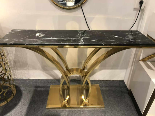 Modern Gold Electroplated Display Table Marvel A Sculptural Console Table Made with Stainless Steel  Featuring a Luxurious Black Marble Top