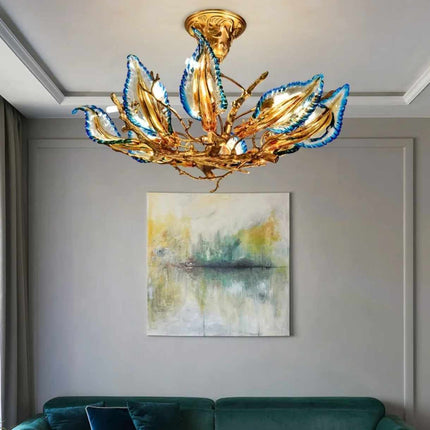 Gilded Bloom A Sculptural Chandelier with Azure-Tipped Petals Illuminating a Modern Art-Filled Space Golden Branches and Vibrant Blue Accents Create a Captivating Focal Point