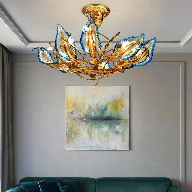 Gilded Bloom A Sculptural Chandelier with Azure-Tipped Petals Illuminating a Modern Art-Filled Space Golden Branches and Vibrant Blue Accents Create a Captivating Focal Point