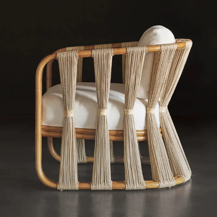 Chair with woven backrest and white cushion on a dark background
