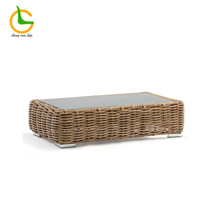 Wicker coffee table with a glass top on a white background