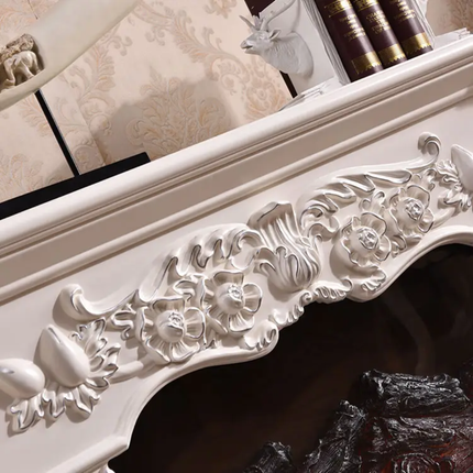 Decorative fireplace mantel with intricate carvings in a room setting.