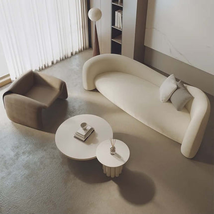 Modern living room with a beige sofa, armchair, and coffee table.