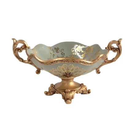 Decorative bowl with gold embellishments on a white background
