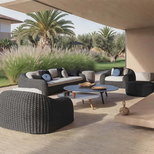 Outdoor patio with modern furniture and palm trees in the background