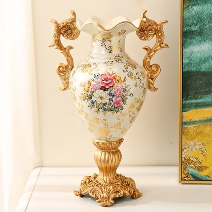 Decorative vase with floral design and gold accents on a white surface.