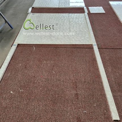 Red stone paver with 'Wallest' branding on a construction site