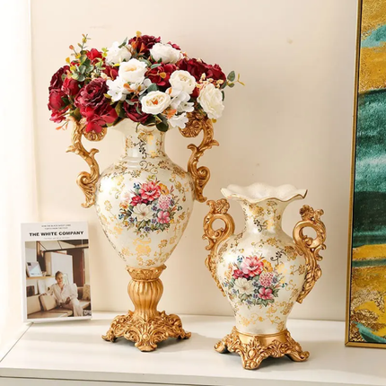 Decorative vases with floral patterns and gold accents on a shelf.