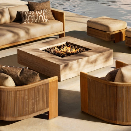 Outdoor patio furniture set with fire pit by a body of water