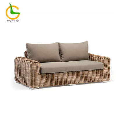Brown wicker outdoor sofa with cushions on a white background