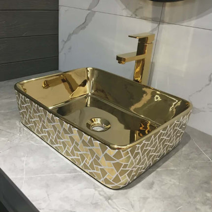 Gold-patterned rectangular sink with a matching faucet on a marble countertop.