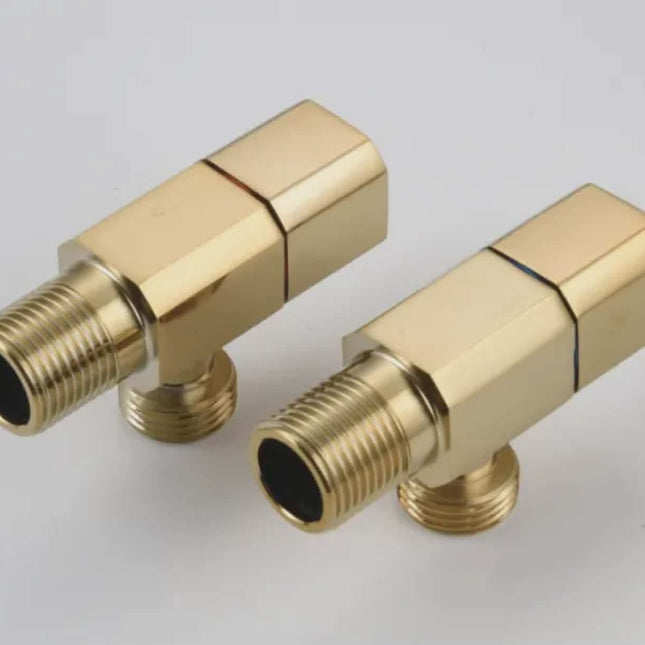 Two gold brass plumbing connectors on a light gray background
