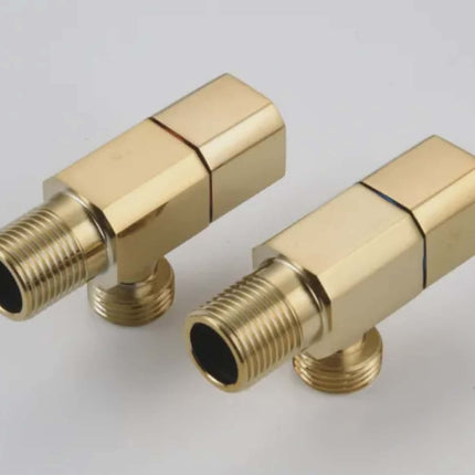 Two gold brass plumbing connectors on a light gray background