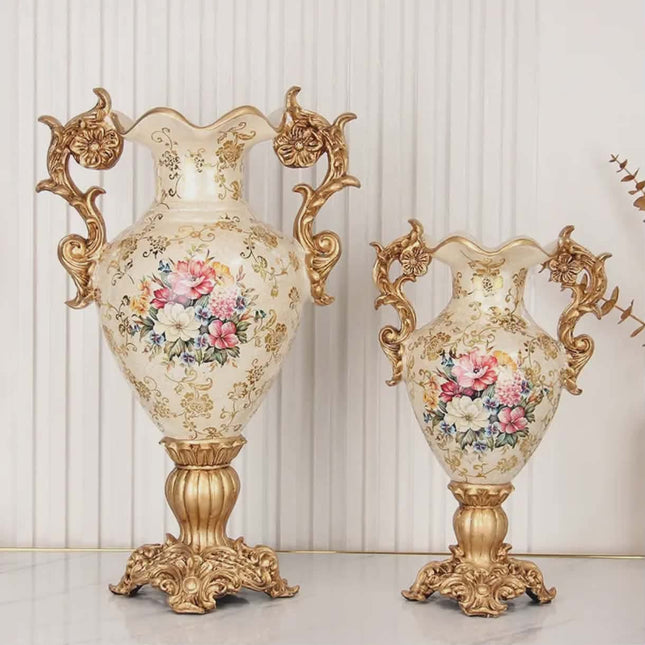 Two ornate vases with floral designs and gold accents on a white background