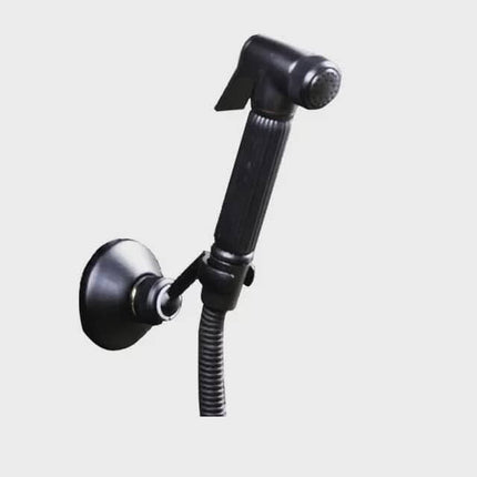 Black shower head with flexible hose on a light gray background