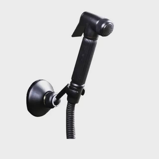 Black shower head with flexible hose on a light gray background