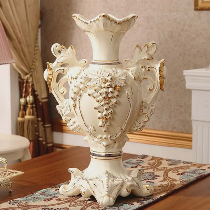 Decorative white vase with gold accents on a table