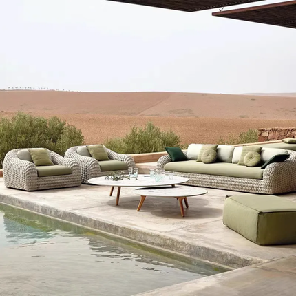 Outdoor patio furniture set with a pool and desert landscape in the background