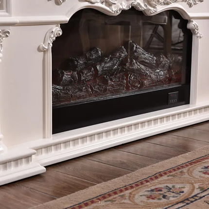 White decorative fireplace with a black screen on a wooden floor.