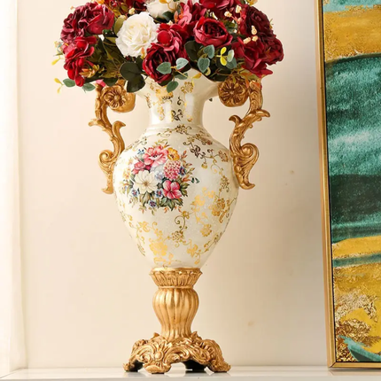 Decorative vase with floral design and gold accents on a white surface.