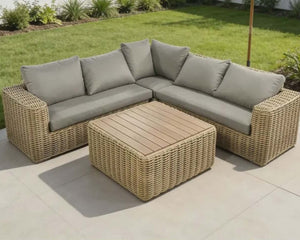 Outdoor patio furniture set with a sectional sofa and coffee table on a patio.