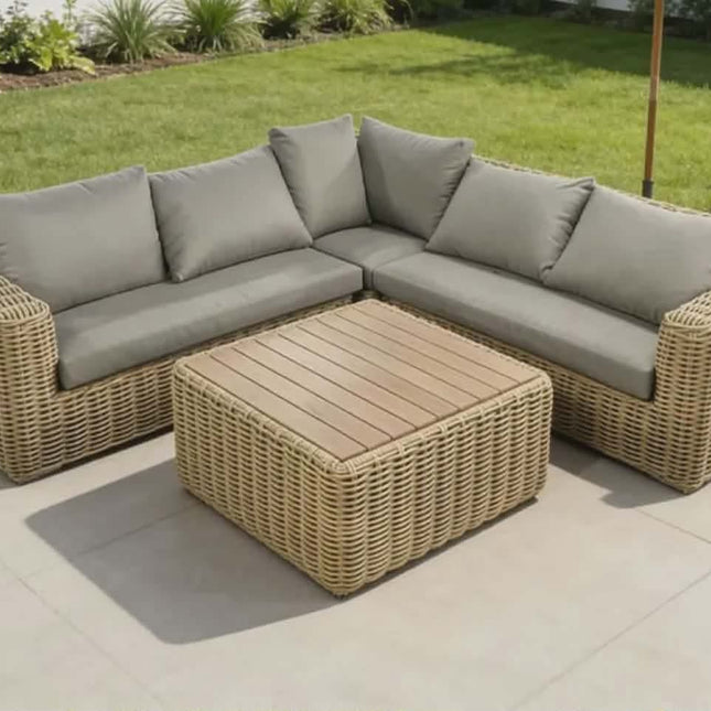 Outdoor patio furniture set with a sectional sofa and coffee table on a patio.