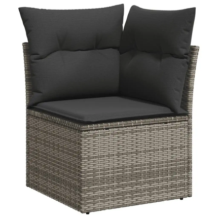 Corner chair with wicker frame and dark cushions on a white background