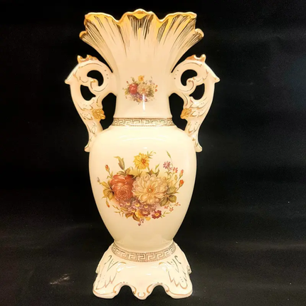 Decorative vase with floral patterns and gold accents on a black background