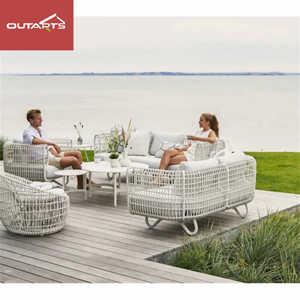 Outdoor furniture set with people on a deck by a lake, featuring the Outarts brand.