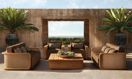 Outdoor patio furniture set with plants and a concrete wall background