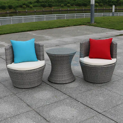 Outdoor patio set with two chairs and a table on a paved area.