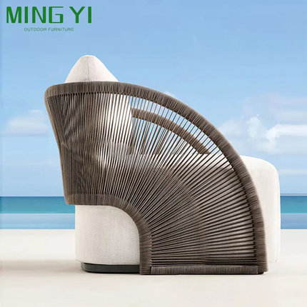 Modern outdoor chair with wicker backrest against a blue sky background, branded as MING YI.