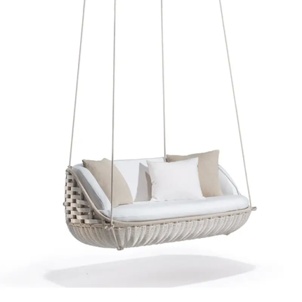 Hanging chair with white cushion and beige pillows on a white background
