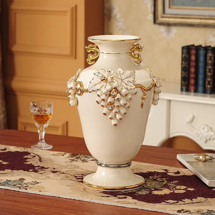 Decorative white vase with gold accents on a table in a room setting.