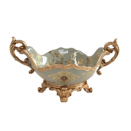 Decorative bowl with gold embellishments on a white background