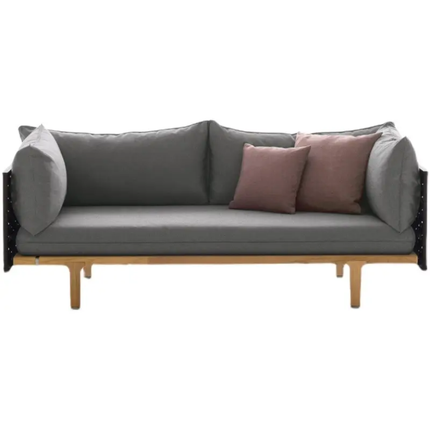 Gray sofa with wooden legs and pink cushions on a white background