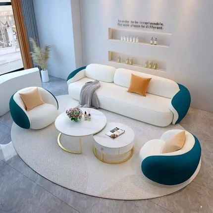 Modern living room with white and teal sofa set, round coffee tables, and decorative items.