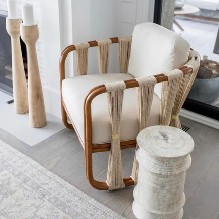 Rattan chair with white cushion in a modern interior setting
