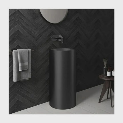 Modern Matte Black Pedestal Sink with Wall-Mounted Faucet – Minimalist Luxury Bathroom Design with Dark Herringbone Wall Tiles