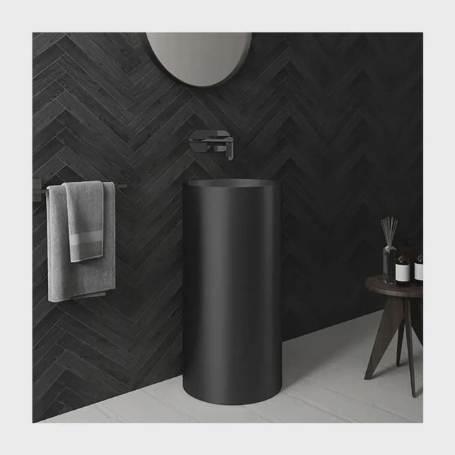 Modern Matte Black Pedestal Sink with Wall-Mounted Faucet – Minimalist Luxury Bathroom Design with Dark Herringbone Wall Tiles