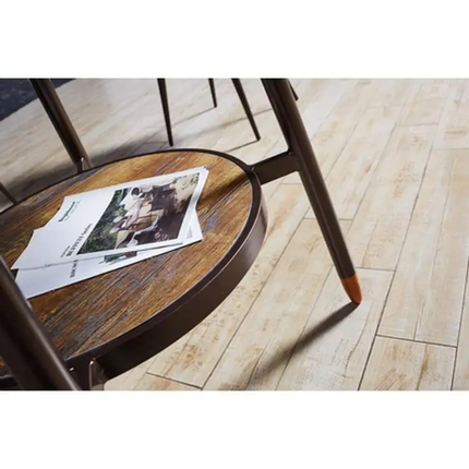 Round wooden table with a metal frame on a wooden floor