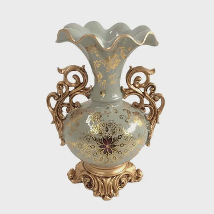 Decorative vase with gold floral patterns on a light blue background