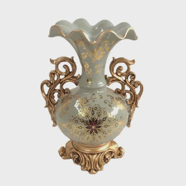 Decorative vase with gold floral patterns on a light blue background