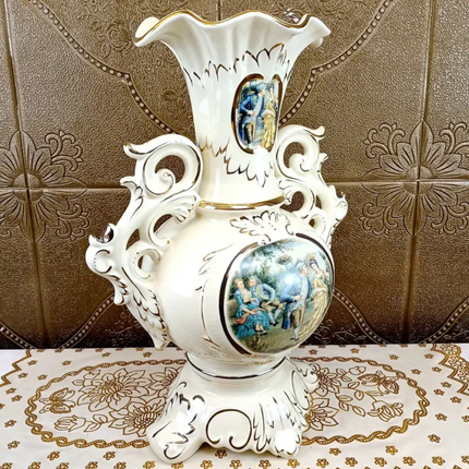 Decorative white vase with artistic designs on a patterned surface